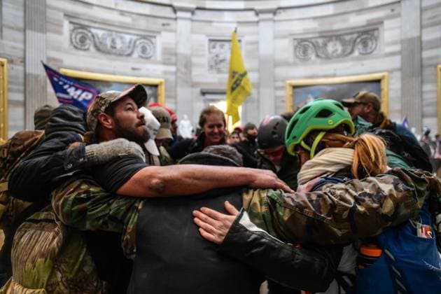 January 6, 2021, Washington, District of Columbia, USA: A group of prays at the US Capitol Rotunda, as Pro-Trump mobs storm the US Capitol Wednesday, marauding in hallways, offices and forcing their way into Senate chambers in a stunning attempt to stop the official counting of electoral votes confirming the presidential election the Joe Biden. Washington USA  - ZUMA 20210106_mda_l113_198 Copyright: xMiguelxJuarezxLugox