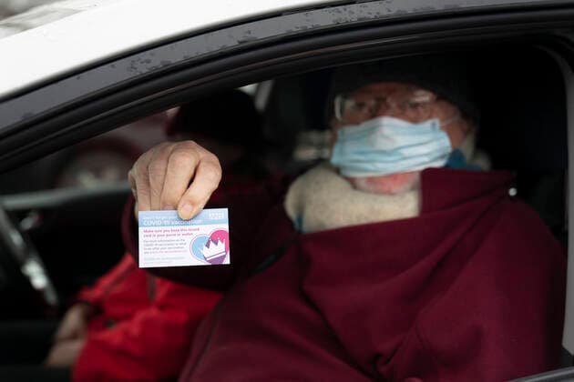 (210107) -- GREATER MANCHESTER, Jan. 7, 2021 -- A man holds a vaccination record card after receiving the second dose of the Pfizer-BioNTech COVID-19 vaccine at Hyde Leisure Centre in Greater Manchester, Britain, on Jan. 7, 2021. British Prime Minister Boris Johnson told MPs on Wednesday that the government will use every available second of the lockdown to place an invisible shield around elderly and vulnerable people through the rollout of COVID-19 vaccines in the coming weeks. (Photo by Xinhua) BRITAIN-GREATER MANCHESTER-COVID-19-VACCINE JonxSuper 