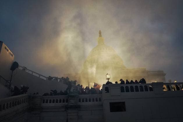 January 6, 2021, Washington, District of Columbia, USA: A flash bang grenade lights up the Capital Building as Trump supporters storm and rally at the building protesting the 2020 election results in Washington. Four people died during violent pro-Trump protests, one woman was shot inside the Capitol, and three others died after suffering medical emergencies, police said. Washington USA - ZUMAb148 20210106_zap_b148_126 Copyright: xBryanxSmithx