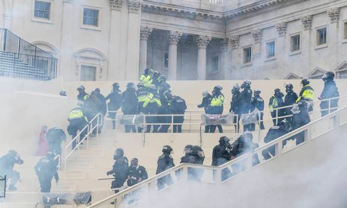 Pro-Trump Riot in Washington DC Police seen retrieting after overwelmed by pro-Trump protesters at Capitol building. Illegal invasion of Capitol building produced four death of protesters, 50 police officers were wounded and lots of property damaged. Washington DC District of Columbia United States Copyright: LevxRadin