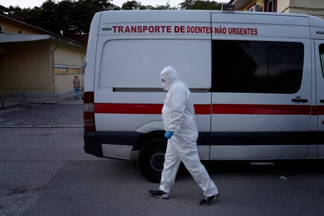 January 8, 2021, Lisbon, Portugal: A healthcare worker wearing a protective suit walks by an ambulance at the Curry Cabral Hospital in Lisbon, Portugal, January 8, 2020. Portugal reported today a record 10,176 new COVID-19 cases and 118 deaths in 24 hours, the highest daily figures since the beginning of the pandemic, according to the national health authority Lisbon Portugal - ZUMAf123 20210108_zap_f123_009 Copyright: xPedroxFiuzax