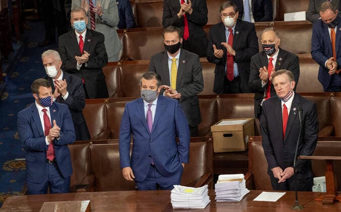 Rep. Paul Gosar, R-AZ, (R) and Sen. Ted Cruz, R-TX, (C) are applauded as they object to the certification of Arizona s Electoral College votes during a joint session of Congress the U.S. Capitol in Washington, DC on Wednesday, January 6, 2021. A pro-Trump mob broke into the U.S. Capitol causing destruction, an evacuation and at least four deaths. After a long delay Congress certified Joe Biden s victory in the Presidential election.  WAS20210109103 PatxBenic