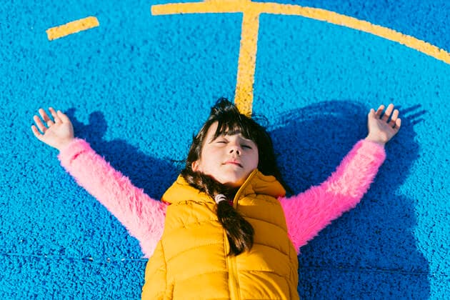 Girl relaxing with arms raised on basketball court model released Symbolfoto ERRF04662