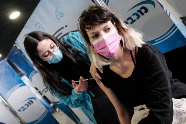 January 14, 2021, Jerusalem, Israel: Nurses administer COVID-19 vaccines at the Pais Arena Sports Complex in Jerusalem, converted into a Coronavirus vaccination center. Criteria is now either health workers, education workers, or the general public 50 years of age and above. The number of Israeli citizens who have received at least one dose of the Pfizer BioNTech vaccine has exceeded 2M as a mass vaccination campaign continues, and so does COVID-19 infection in the general public. Jerusalem Israel - ZUMAa126 20210114_zap_a126_001 Copyright: xNirxAlonx