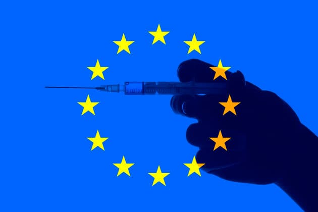 Symbolic image dispute over procurement of Corona vaccine by EU, hand with syringe in front of European flag, Corona crisis, Baden Württemberg, Germany Coronavirus vaccine
