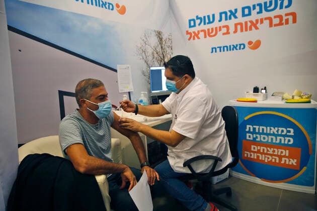 (210114) -- REHOVOT (ISRAEL), Jan. 14, 2021 -- A man receives a COVID-19 vaccine at a health services center in Rehovot, central Israel, on Jan. 14, 2021. Israel s health ministry reported 10,933 new COVID-19 cases on Thursday, bringing the total number in the country to 528,204. (Photo by Xinhua) ISRAEL-REHOVOT-COVID-19-CASES GilxCohenxMagen 