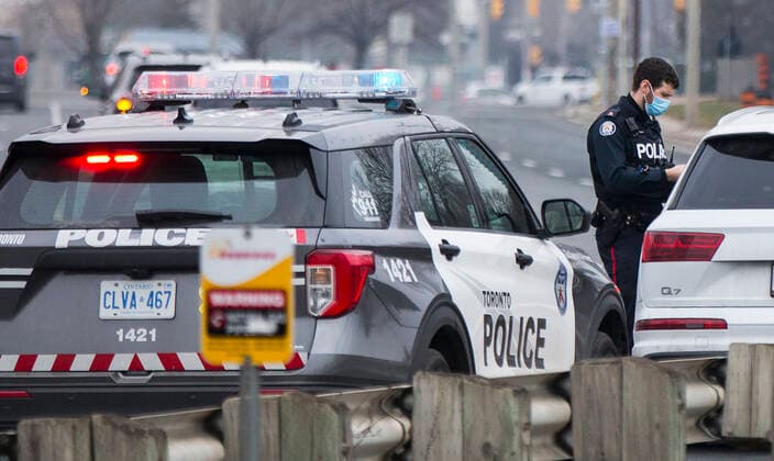 (210114) -- TORONTO, Jan. 14, 2021 -- A police officer wearing a face mask checks a driver s documents in Toronto, Ontario, Canada, on Jan. 14, 2021. Ontario s stay-at-home order went into effect on Thursday, requiring residents to stay home except for essential outings. (Photo by Xinhua) CANADA-ONTARIO-COVID-19-STAY-AT-HOME ORDER ZouxZheng 