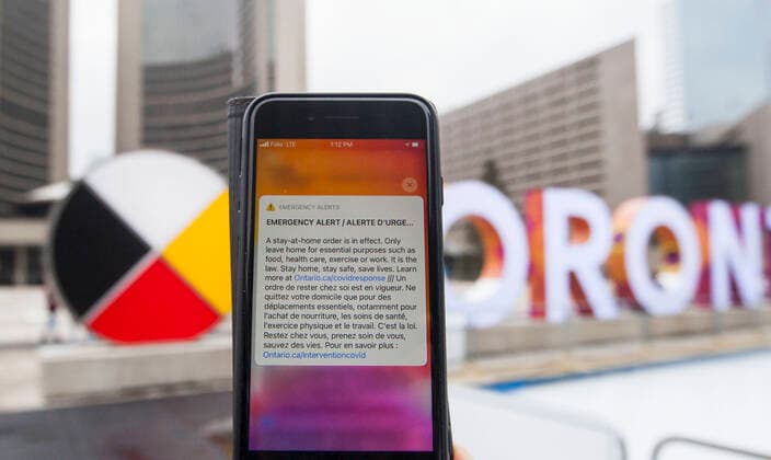 (210114) -- TORONTO, Jan. 14, 2021 -- Photo taken on Jan. 14, 2021 shows an emergency alert of a stay-at-home order on a cellphone in Toronto, Ontario, Canada. Ontario s stay-at-home order went into effect on Thursday, requiring residents to stay home except for essential outings. (Photo by Xinhua) CANADA-ONTARIO-COVID-19-STAY-AT-HOME ORDER ZouxZheng 