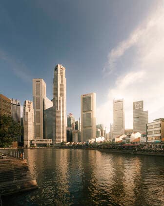 Skyscrapers in Singapore s CBD, adjacent to Boat Quay along the Singapore River. Towers such as OCBC Centre by I.M Pei and UOB Plaza by Kenzo Tange are illuminated by the sunset.  Copyright: xx
