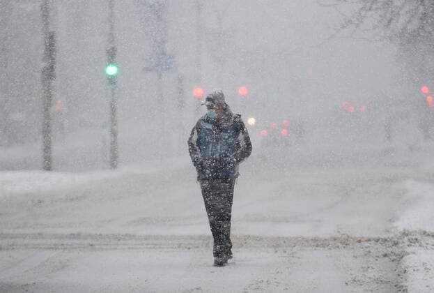 January 16, 2021, Montreal, PQ, Canada: A man wears a face mask as he walks along a street during a snowstorm in Montreal, Saturday, January 16, 2021. Montreal Canada  - ZUMAc35_ 20210116_zaf_c35_012 Copyright: xGrahamxHughesx