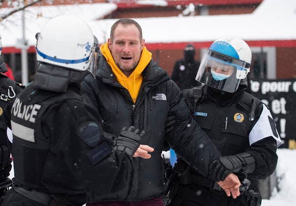January 16, 2021, Montreal, PQ, Canada: A man is removed by police from a demonstration opposing restrictions imposed by the Quebec government to help stop the spread of COVID-19 in Montreal, Saturday, January 16, 2021, as the pandemic continues in Canada and around the world. The Quebec government has imposed a lockdown and a curfew to help curb the spread of COVID-19. The curfew begins at 8 p.m until 5 a.m and lasting until February 8. Montreal Canada  - ZUMAc35_ 20210116_zaf_c35_042 Copyright: xGrahamxHughesx