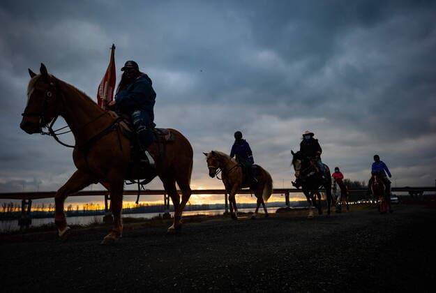 January 17, 2021, Mission, BC, Canada: People on horseback are silhouetted while leading an anti-bullying parade of more than 1,000 vehicles in support of a transgender teenager who was allegedly assaulted outside a school, in Mission, B.C., on Sunday, January 17, 2021. According to RCMP two students were arrested and charges were recommended in regards to the incident that was recorded and posted online. Mission Canada  - ZUMAc35_ 20210117_zaf_c35_041 Copyright: xDarrylxDyckx