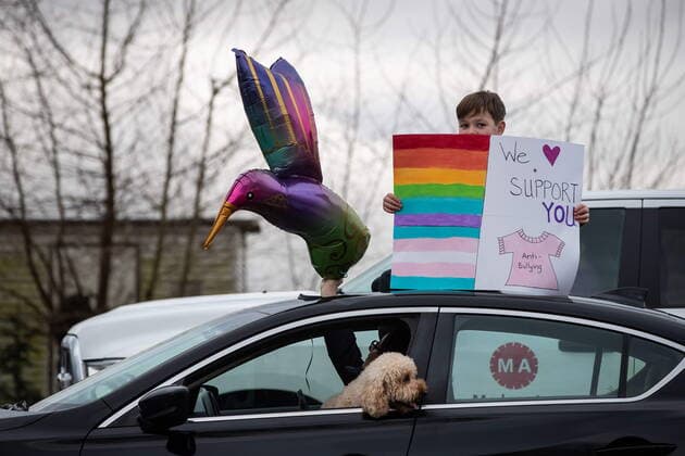 January 17, 2021, Mission, BC, Canada: A child standing through the sunroof of a vehicle holds a sign as motorists wait to participate in an anti-bullying parade of more than 1,000 vehicles in support of a transgender teenager who was allegedly assaulted outside a school, in Mission, B.C., on Sunday, January 17, 2021. According to RCMP two students were arrested and charges were recommended in regards to the incident that was recorded and posted online. Mission Canada  - ZUMAc35_ 20210117_zaf_c35_053 Copyright: xDarrylxDyckx