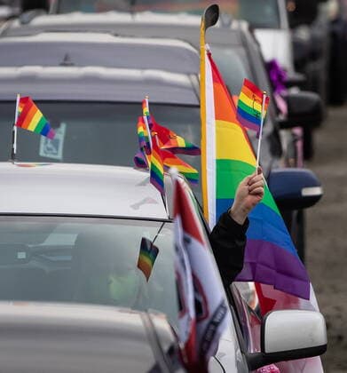 January 17, 2021, Mission, BC, Canada: A motorist holds a rainbow flag while waiting to participate in an anti-bullying parade of more than 1,000 vehicles in support of a transgender teenager who was allegedly assaulted outside a school, in Mission, B.C., on Sunday, January 17, 2021. According to RCMP two students were arrested and charges were recommended in regards to the incident that was recorded and posted online. Mission Canada  - ZUMAc35_ 20210117_zaf_c35_054 Copyright: xDarrylxDyckx