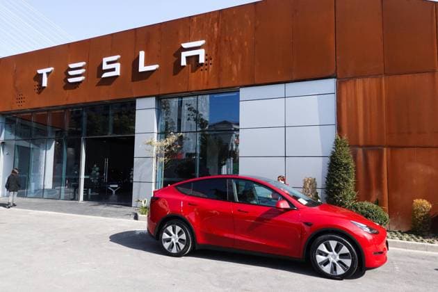 SHANGHAI, CHINA - JANUARY 18: A customer stands by her new China-made Model Y compact crossover vehicle at a Tesla showroom on January 18, 2021 in Shanghai, China.  Copyright: xVCGx CFP111314122414