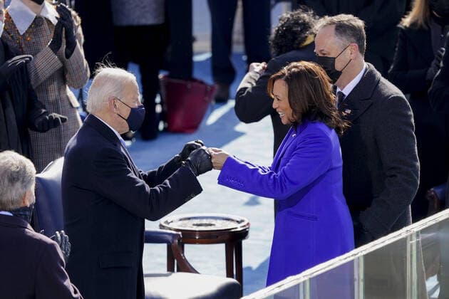 U.S. President Joe Biden, left, fist bumps Vice President Kamala Harris during the 59th presidential inauguration in Washington, D.C., U.S., on Wednesday, Jan. 20, 2021. Biden will propose a broad immigration overhaul on his first day as president, including a shortened pathway to U.S. citizenship for undocumented migrants - a complete reversal from Donald Trump s immigration restrictions and crackdowns, but one that faces major roadblocks in Congress.  WAP202101209002 KevinxDietsch