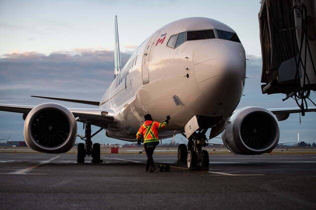 January 21, 2021, Richmond, BC, Canada: A ground worker approaches a WestJet Airlines Boeing 737 Max aircraft after it arrived at Vancouver International Airport in Richmond, B.C., on Thursday, January 21, 2021. The flight from Calgary is the first commercial Boeing 737 Max flight in Canada since the aircraft was grounded worldwide in 2019 following two deadly crashes. Transport Canada lifted its grounding order for the Max on Wednesday after approving design changes to the plane and requiring pilots to undergo additional training. Richmond Canada  - ZUMAc35_ 20210121_zaf_c35_021 Copyright: xDarrylxDyckx