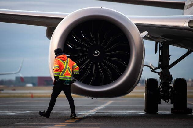 January 21, 2021, Richmond, BC, Canada: A ground worker walks past one of the engines on a WestJet Airlines Boeing 737 Max aircraft after it arrived at Vancouver International Airport in Richmond, B.C., on Thursday, January 21, 2021. The flight from Calgary is the first commercial Boeing 737 Max flight in Canada since the aircraft was grounded worldwide in 2019 following two deadly crashes. Transport Canada lifted its grounding order for the Max on Wednesday after approving design changes to the plane and requiring pilots to undergo additional training. Richmond Canada  - ZUMAc35_ 20210121_zaf_c35_022 Copyright: xDarrylxDyckx