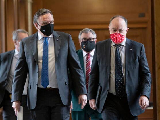 January 21, 2021, Quebec, PQ, Canada: Quebec Premier Francois Legault, left, Quebec Health Minister Christian Dube, right and Horacio Arruda, Quebec director of National Public Health, behind, walk to a news conference on the COVID-19 pandemic, Thursday, January 21, 2021 at the legislature in Quebec City. Quebec Canada - ZUMAc35_ 20210121_zaf_c35_034 Copyright: xJacquesxBoissinotx