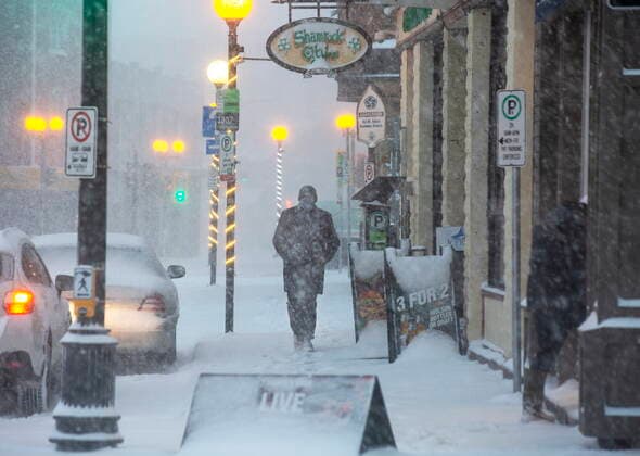 January 21, 2021, St. John S, NL, Canada: Chris Jackson walks along Water Stret in St. JohnÃ¢â‚¬â ¢s NL on Thursday, January 21, 2021 as the first major snow storm of the winter starts to ramp up. St. John S Canada  - ZUMAc35_ 20210121_zaf_c35_075 Copyright: xPaulxDalyx