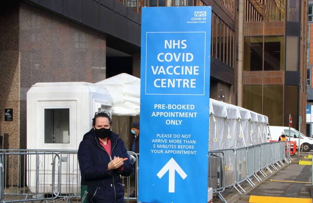 January 21, 2021, London, United Kingdom: A woman wearing a face facemask checks into the vaccination centre..A steady stream of elderly people with pre-booked appointments at the new Covid-19 Vaccination hub at the Olympic Office Centre, near London s Wembley Stadium. .It is one of 10 new large scale Vaccination centres opened this week, to join the seven already in use across the country. So far 4.9 million people across the UK have received the first dose of vaccine and the government aims for that number to rise to 15 million by 15 February. London United Kingdom - ZUMAs197 20210121_zaa_s197_151 Copyright: xKeithxMayhewx