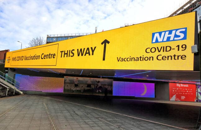 January 21, 2021, London, United Kingdom: Signage directs the public to the NHS vaccination centre..A steady stream of elderly people with pre-booked appointments at the new Covid-19 Vaccination hub at the Olympic Office Centre, near London s Wembley Stadium. .It is one of 10 new large scale Vaccination centres opened this week, to join the seven already in use across the country. So far 4.9 million people across the UK have received the first dose of vaccine and the government aims for that number to rise to 15 million by 15 February. London United Kingdom - ZUMAs197 20210121_zaa_s197_145 Copyright: xKeithxMayhewx
