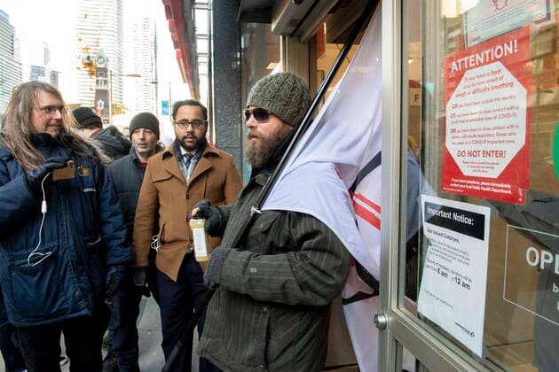 January 23, 2021, Toronto, on, Canada: An anti-mask protester exits a Shoppers Drugmart in Toronto on Saturday January 23, 2021 after dozens of maskless demonstrators entered the store.. The protest travelled through the downtown core for hours and was not stopped by police. Toronto Canada  - ZUMAc35_ 20210123_zaf_c35_030 Copyright: xFrankxGunnx