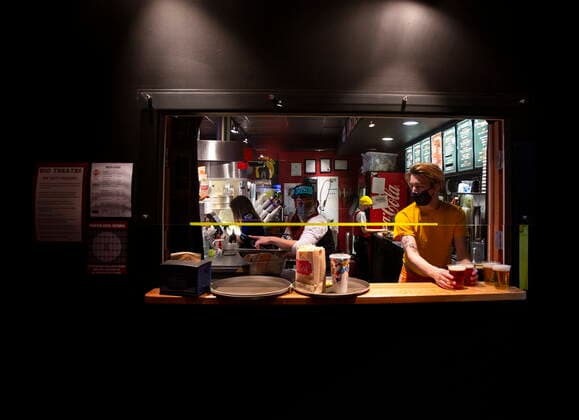 January 23, 2021, Vancouver, BC, Canada: Rio Theatre staff work to fill orders at the concession stand on the theatre s first day open as a sports bar in Vancouver, Saturday, Jan. 23, 2021. The independent movie theatre, which has been closed due to provincial public health restrictions, is now open as a sports bar. Vancouver Canada  - ZUMAc35_ 20210123_zaf_c35_058 Copyright: xMarissaxTielx