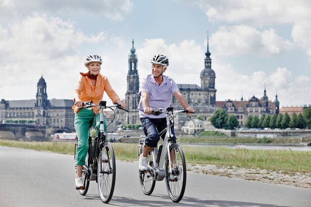 Senior couple cycling electric bicycle on road at Hausmannsturm, Dresden, Germany model released Symbolfoto RORF02561
