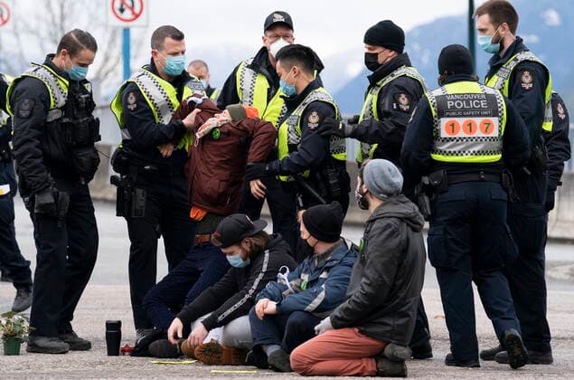 January 29, 2021, Vancouver, BC, Canada: Members of the Extinction Rebellion get arrested after blocking the entrance to the Port of Vancouver, Friday, January 29, 2021. The protesters planned the march and blockade as a part of their anti-pipeline campaign. Vancouver Canada  - ZUMAc35_ 20210129_zaf_c35_065 Copyright: xJonathanxHaywardx