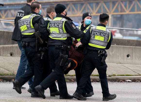 January 29, 2021, Vancouver, BC, Canada: Members of the Extinction Rebellion get arrested after blocking the entrance to the Port of Vancouver, Friday, January 29, 2021. The protesters planned the march and blockade as a part of their anti-pipeline campaign. Vancouver Canada  - ZUMAc35_ 20210129_zaf_c35_066 Copyright: xJonathanxHaywardx