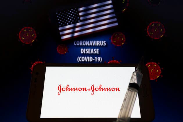 January 30, 2021, Asuncion, Paraguay: Illustration photo of logo of Johnson & Johnson seen displayed on a smartphone behind a syringe with needle backdropped by waving flag of the United States, the words coronavirus disease (COVID-19) and visual representation of virus. Johnson & Johnson announced on Jan 29 their single-shot Janssen COVID-19 vaccine candidate met primary endpoints in interim analysis of its Phase 3 ENSEMBLE clinical trial. Asuncion Paraguay - ZUMAc217 20210130_zip_c217_006 Copyright: xAndrexM.xChangx
