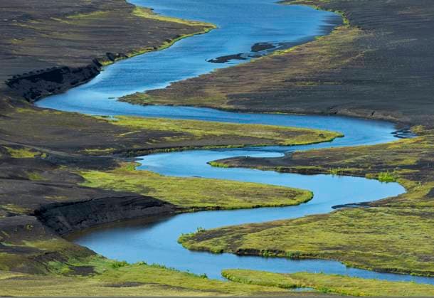 Creative Highlights World From above of picturesque landscape of bright blue river flowing among volcanic terrain in Iceland, Model released Copyright: xPacoxFarerox MR