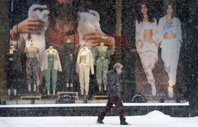 February 2, 2021, Montreal, PQ, Canada: A pedestrian walks down Saint-Catherine street during a snowstorm in Montreal, on Tuesday, February 2, 2021. Quebec Premier Francois Legault is expected to announce a loosening of some restrictions including the reopening of non-essential businesses province-wide. Montreal Canada  - ZUMAc35_ 20210202_zaf_c35_037 Copyright: xPaulxChiassonx