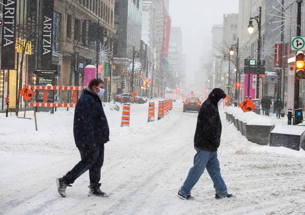 February 2, 2021, Montreal, PQ, Canada: Pedestrians cross St. Catherine street during a snowstorm Tuesday, February 2, 2021 in Montreal. Montreal Canada  - ZUMAc35_ 20210202_zaf_c35_057 Copyright: xRyanxRemiorzx