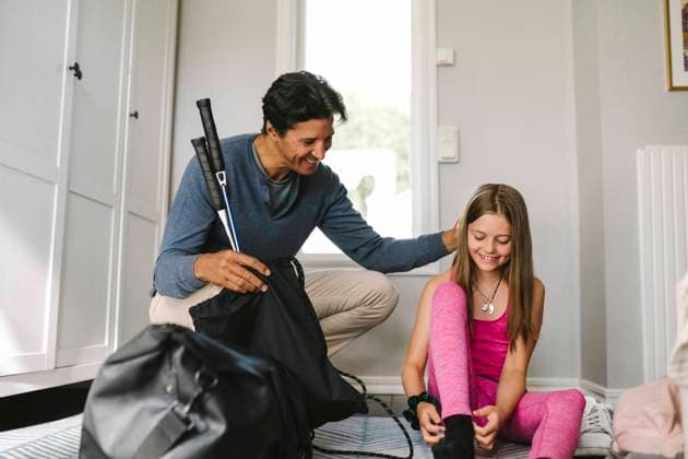 Father with badminton caressing daughter while sitting by at home Sweden, Gothenburg, model released, property released Copyright: xMaskotx , MA83680