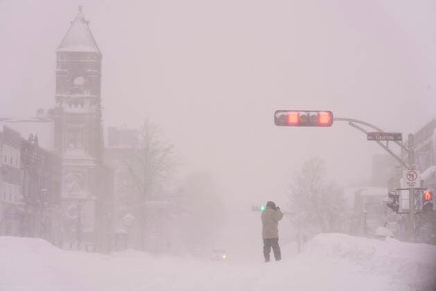 February 8, 2021, Charlottetown, PE, Canada: A person takes a photo on Grafton Street during a snowstorm in Charlottetown on Monday, Feb. 8, 2021. Charlottetown Canada  - ZUMAc35_ 20210208_zaf_c35_002 Copyright: xJohnxMorrisx