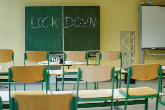 Symbolic picture school and classroom in lockdown Symbolic picture classroom of a school with a blackboard and the inscription lockdown The conference of state premiers discusses the opening of schools in Germany