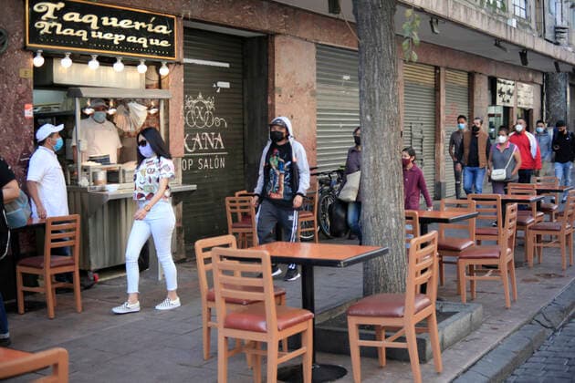 February 9, 2021, Mexico City, Mexico City, Mexico: A person sits at a table outside of a restaurant, after closed several days due red alert by Covid. The Mexican Government allowed the reopening of restaurants with outdoor service, , as an attempt to prevent spread of the Virus February 9, 2021 in Mexico City, Mexico Mexico City Mexico - ZUMAe321 20210209_zia_e321_014 Copyright: xAngelxMoralesxRizox