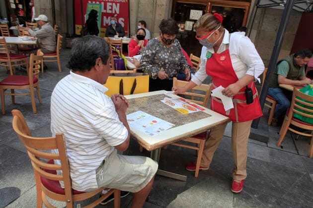 February 9, 2021, Mexico City, Mexico City, Mexico: A person sits at a table outside of a restaurant, after closed several days due red alert by Covid. The Mexican Government allowed the reopening of restaurants with outdoor service, , as an attempt to prevent spread of the Virus February 9, 2021 in Mexico City, Mexico Mexico City Mexico - ZUMAe321 20210209_zia_e321_032 Copyright: xAngelxMoralesxRizox