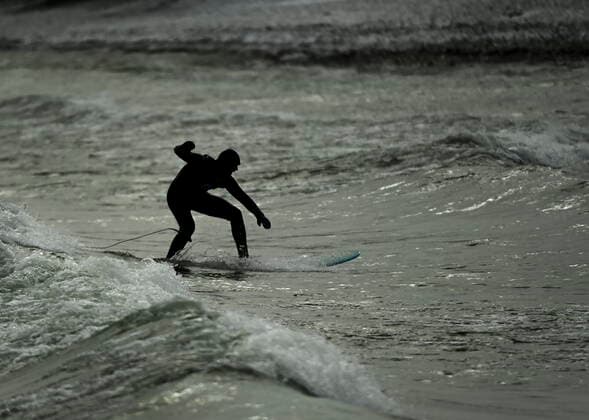 February 12, 2021, Toronto, on, Canada: A man surfs in the frigid ice cold waters of Lake Ontario during the COVID-19 pandemic in Toronto on Friday, February 12, 2021. Toronto Canada  - ZUMAc35_ 20210212_zaf_c35_029 Copyright: xNathanxDenettex