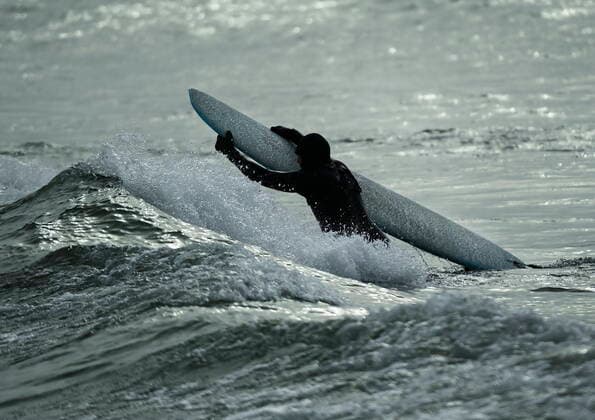 February 12, 2021, Toronto, on, Canada: A man surfs in the frigid ice cold waters of Lake Ontario during the COVID-19 pandemic in Toronto on Friday, February 12, 2021. Toronto Canada  - ZUMAc35_ 20210212_zaf_c35_031 Copyright: xNathanxDenettex