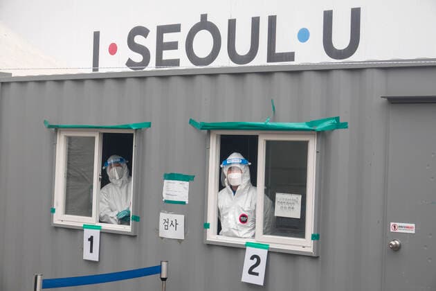 COVID-19 testing, Feb 14, 2021 : Nurses wait for people to take samples from them during a free COVID-19 testing at a makeshift clinic in Seoul, South Korea. South Korea is going to begin its first inoculations against the COVID-19 on February 26 with COVID-19 vaccine developed by British-Swedish pharmaceutical giant and Oxford University, AstraZeneca.  (154120597)