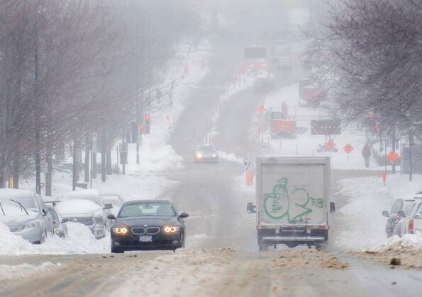 February 16, 2021, Montreal, PQ, Canada: Cars move along a street during a snowstorm in Montreal, Tuesday, February 16, 2021. Montreal Canada  - ZUMAc35_ 20210216_zaf_c35_024 Copyright: xGrahamxHughesx