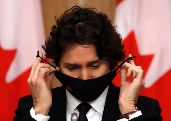 February 16, 2021, Ottawa, on, Canada: Prime Minister Justin Trudeau puts on his mask at a press conference in Ottawa on Tuesday, Feb. 16, 2021. Ottawa Canada  - ZUMAc35_ 20210216_zaf_c35_035 Copyright: xPatrickxDoylex