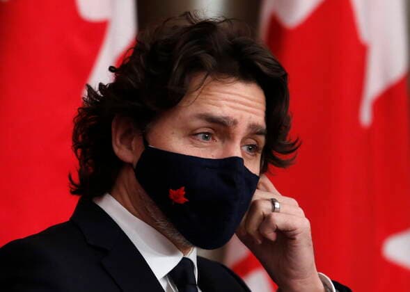 February 16, 2021, Ottawa, on, Canada: Prime Minister Justin Trudeau removes his mask at a press conference in Ottawa on Tuesday, Feb. 16, 2021. Ottawa Canada  - ZUMAc35_ 20210216_zaf_c35_038 Copyright: xPatrickxDoylex