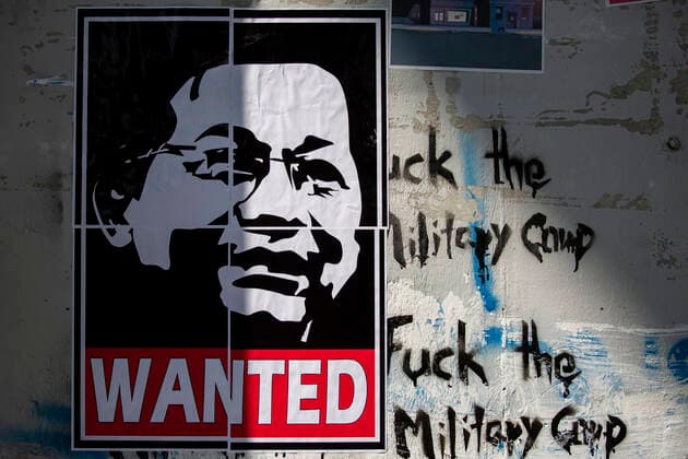 February 13, 2021, Yangon, Myanmar: Protester put wanted poster of Senior General Min Aung Hlaing on the wall during the demonstration against the military coup. A massive crowd took to the streets of Yangon to protest against the coup and demanded the release of Aung San Suu Kyi as the government cut off the internet. Myanmar s military detained State Counsellor of Myanmar Aung San Suu Kyi on February 01, 2021 and declared a state of emergency while seizing the power in the country for a year after losing the election against the National League for Democracy (NLD). Yangon Myanmar - ZUMAotes 20210213_mda_t228_275 Copyright: xThuyaxZawx