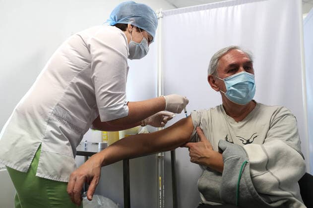 MOSCOW, RUSSIA â€“ FEBRUARY 17, 2021: A man receives the Gam-COVID-Vac vaccine (under the brand name of Sputnik V) at a new temporary COVID-19 vaccination site in the VDNKh Exhibition Centre. A mobile vaccination team is providing vaccines free of charge and without prior sign-up. Since the start of the pandemic, Moscow has confirmed more than 960,600 cases of COVID-19. Since late January, the number of new confirmed cases has been increasing in the Russian capital by more than 1,200 daily. Sergei Savostyanov TASS  TS0F700F