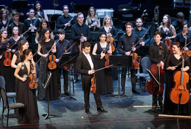 IRKUTSK, RUSSIA - FEBRUARY 19, 2021: Austrian violinist Julian Rachlin (C) is seen after performing during the opening of the Stars on Baikal International Music Festival at Zagursky Music Theatre. The festival is the first large-scale cultural event in the region since the lifting of COVID-19 restrictions. Alexei Kushnirenko TASS  TS0F7446