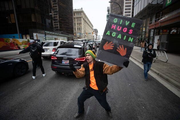 February 20, 2021, Vancouver, BC, Canada: A person holding a sign shouts while marching with people opposed to public health measures to curb the spread of COVID-19, after the B.C. Grand Freedom Rally in Vancouver, on Saturday, February 20, 2021. Vancouver Canada  - ZUMAc35_ 20210220_zaf_c35_030 Copyright: xDarrylxDyckx